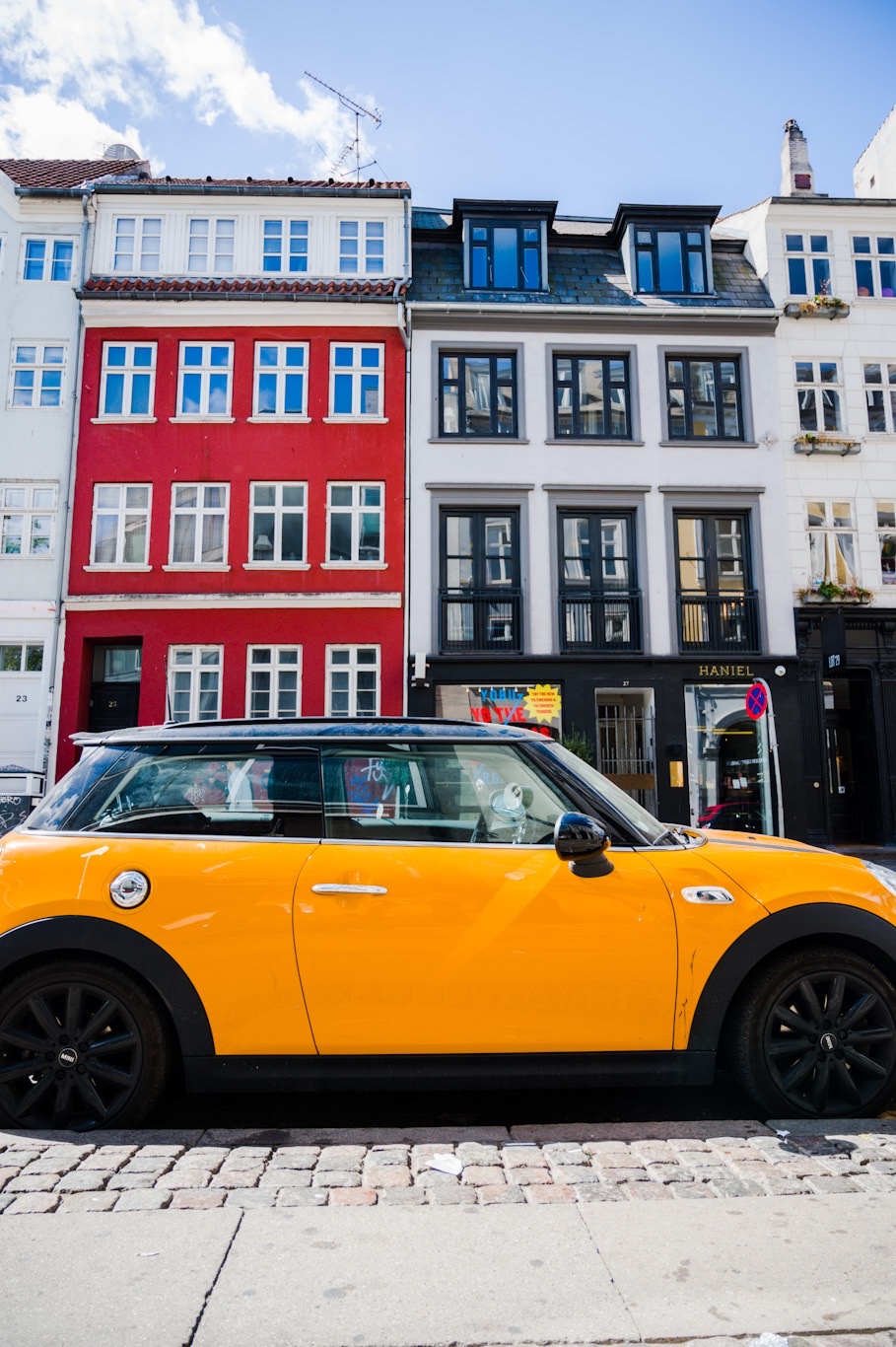 Yellow mini-cooper in historic Copenhagen